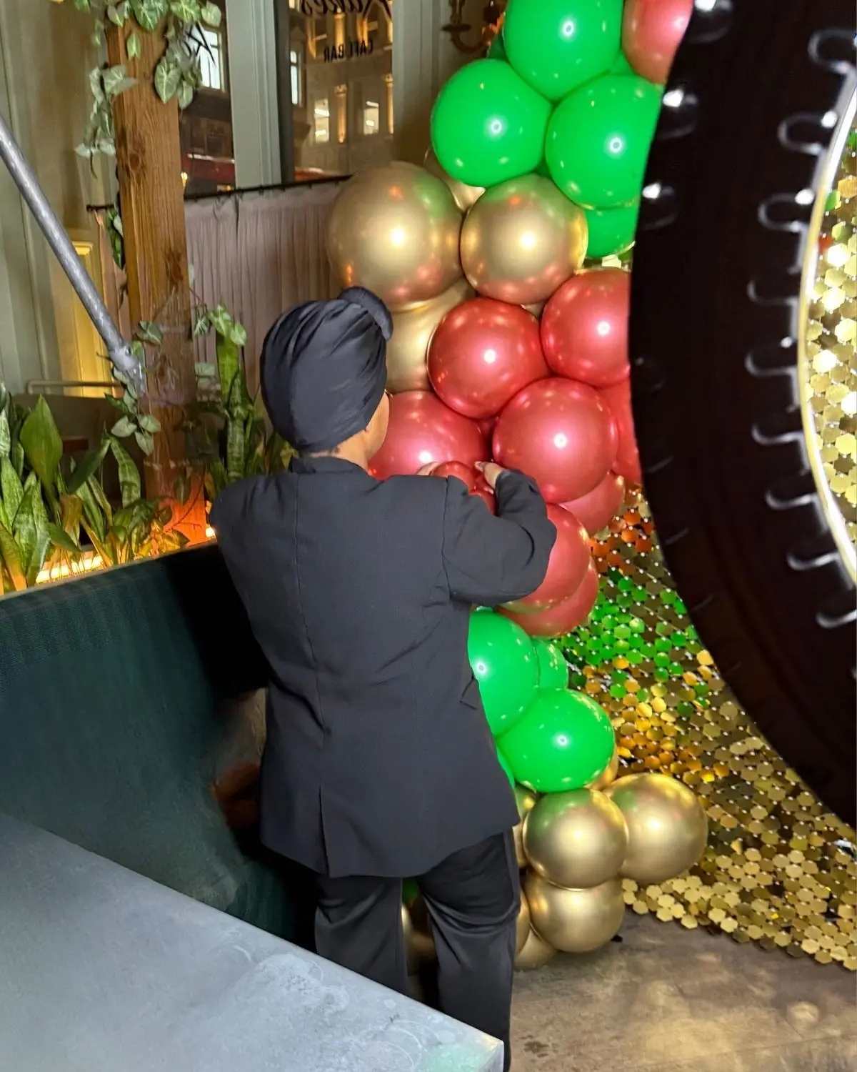 Professional balloon arch installation team setting up at a London venue