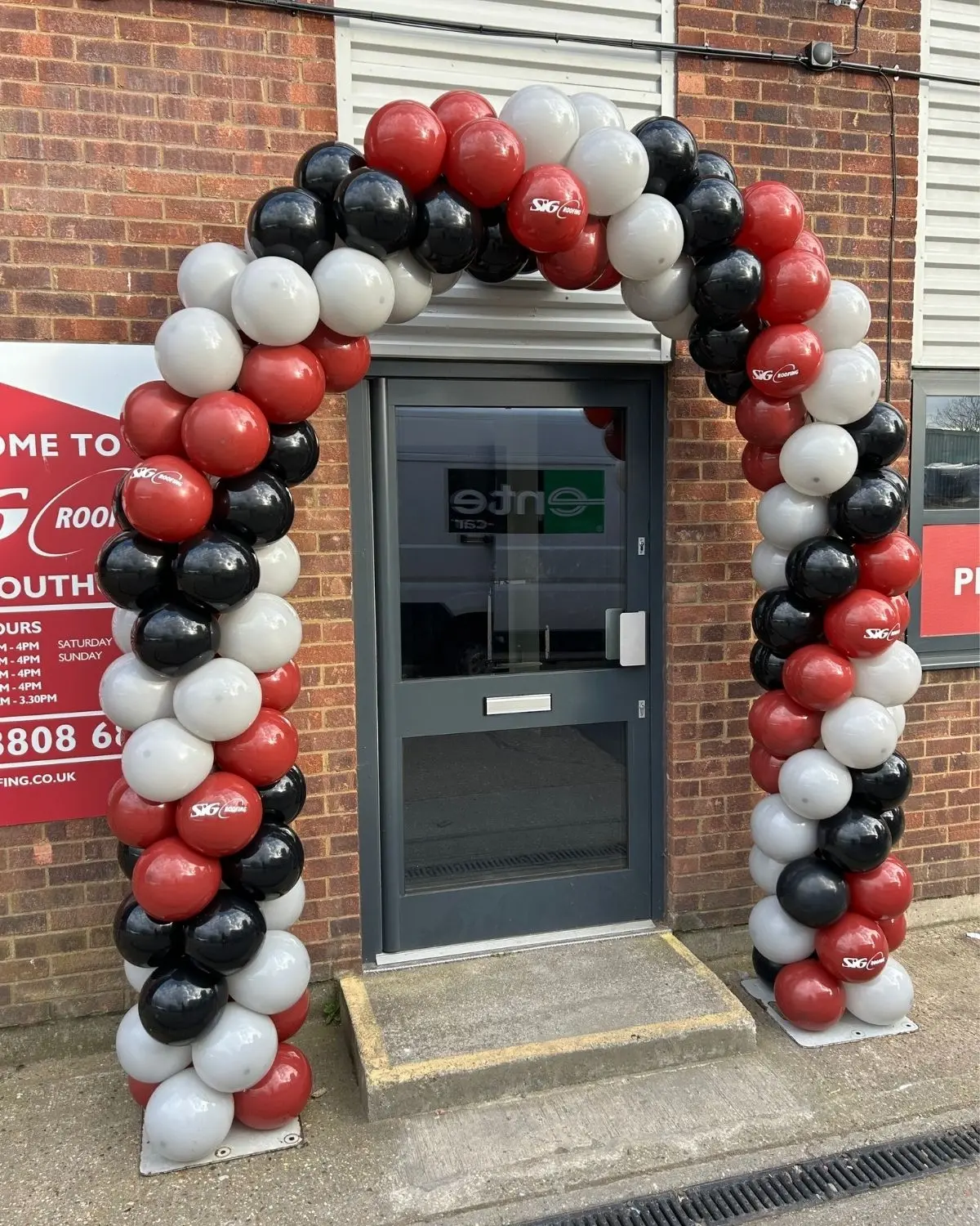Black, white and red classic balloon arch at a branded London event
