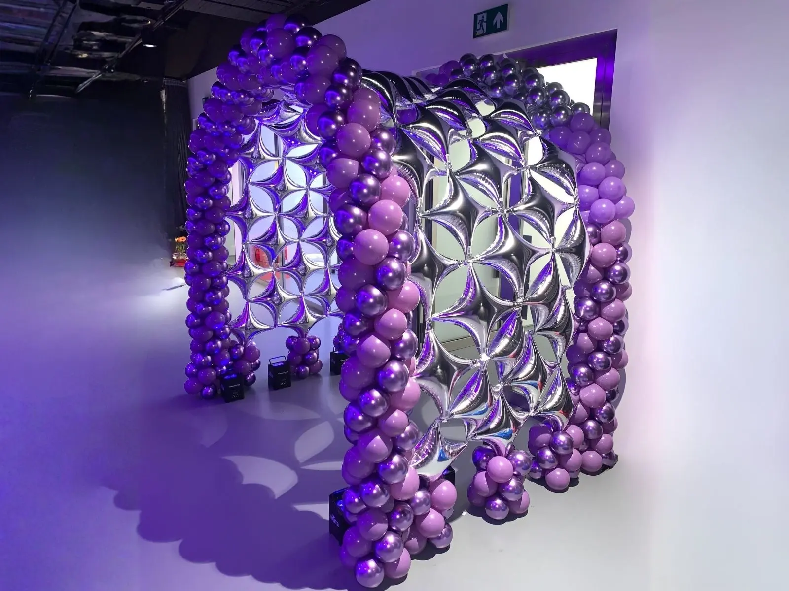 Immersive purple and chrome statement balloon tunnel at a London event