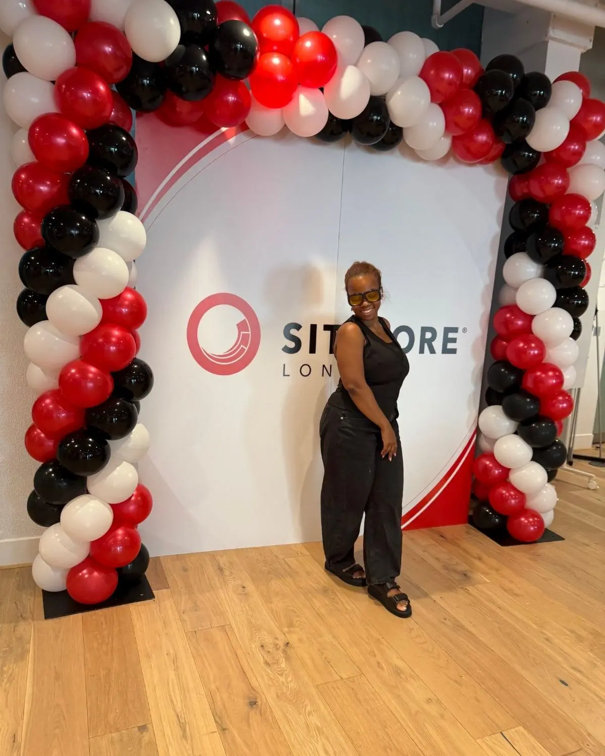 Red, black and white statement balloon installation at a brand launch